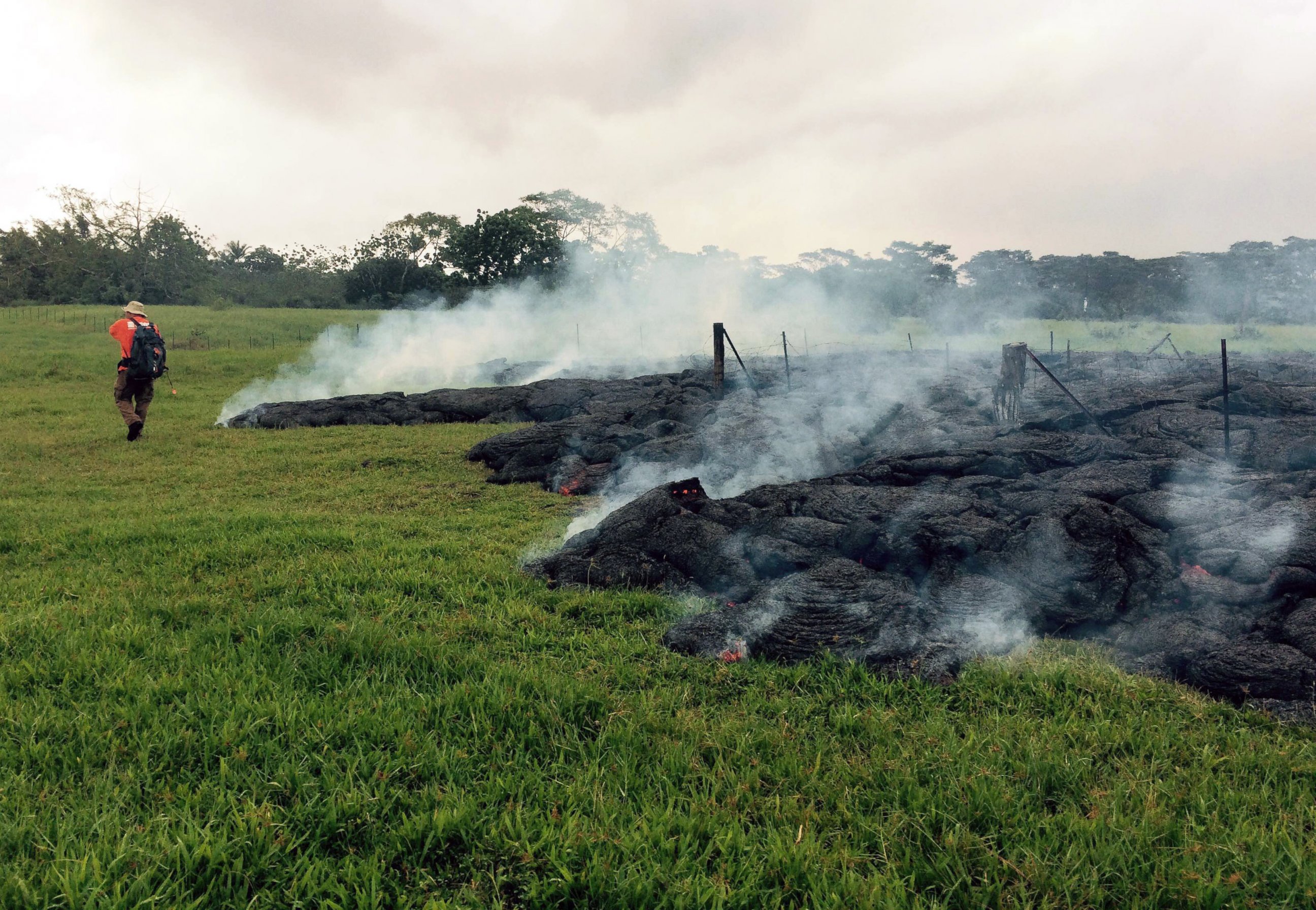 PHOTO: A Hawaii Volcano Observatory geologist maps the margin of the June 27 lava flow in the open field below Cemetery Road near the town of Pahoa on the Big Island of Hawaii, Oct. 26, 2014.