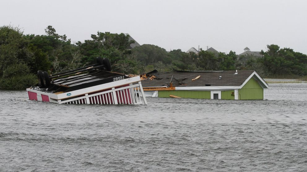 Two trailers sit overturned in the creek behind the Hatteras Sands Campground in Hatteras, N.C., Sept. 3, 2016 after Tropical Storm Hermine passed the Outer Banks. The storm is expected to dump several inches of rain in parts of coastal Virginia, Maryland, Delaware, New Jersey and New York as the Labor Day weekend continues.
