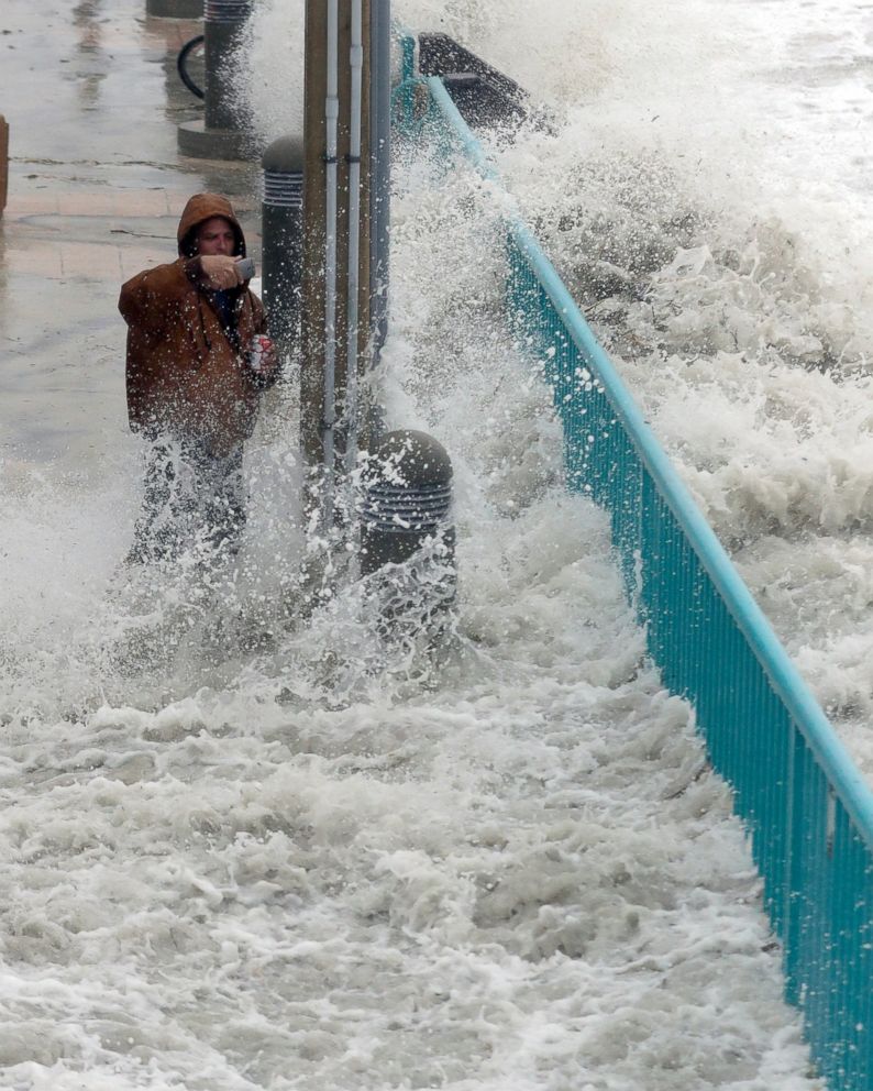 PHOTO: Brian Johns is hit by a wave as he tries to video the effects of Hurricane Matthew, Oct. 7, 2016, in Daytona Beach, Fla.