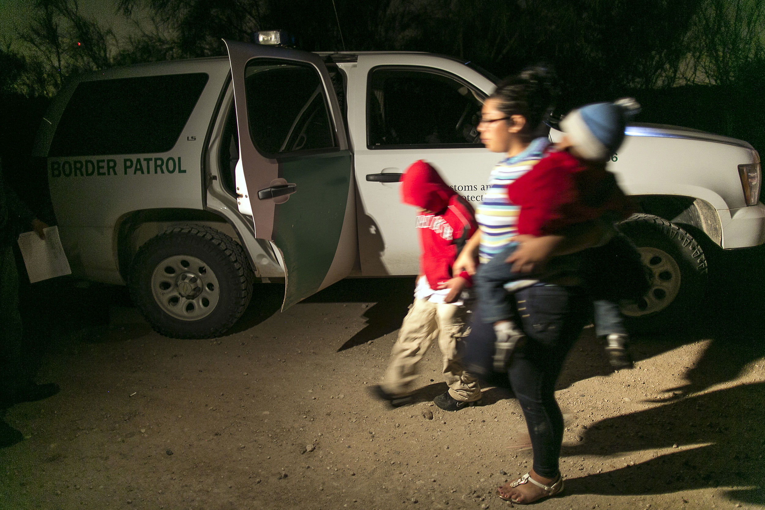PHOTO: In this July 3, 2014 photo, a mother from Honduras traveling with her nine-year-old son and one-year-old daughter prepare to get into a U.S. Customs and Border Protection Services agent's truck after crossing the Rio Grande near McAllen, Texas.