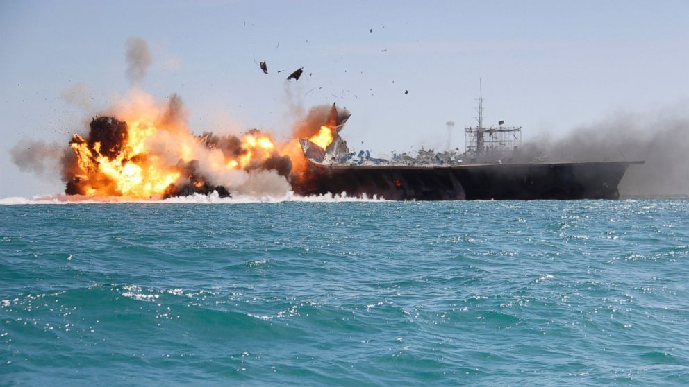 In this picture released by the Iranian Tasnim news agency, Feb. 25, 2015, shows a replica of a U.S. aircraft carrier exploded by the Revolutionary Guard's speedboats during large-scale naval drills near the entrance of the Persian Gulf, Iran. 