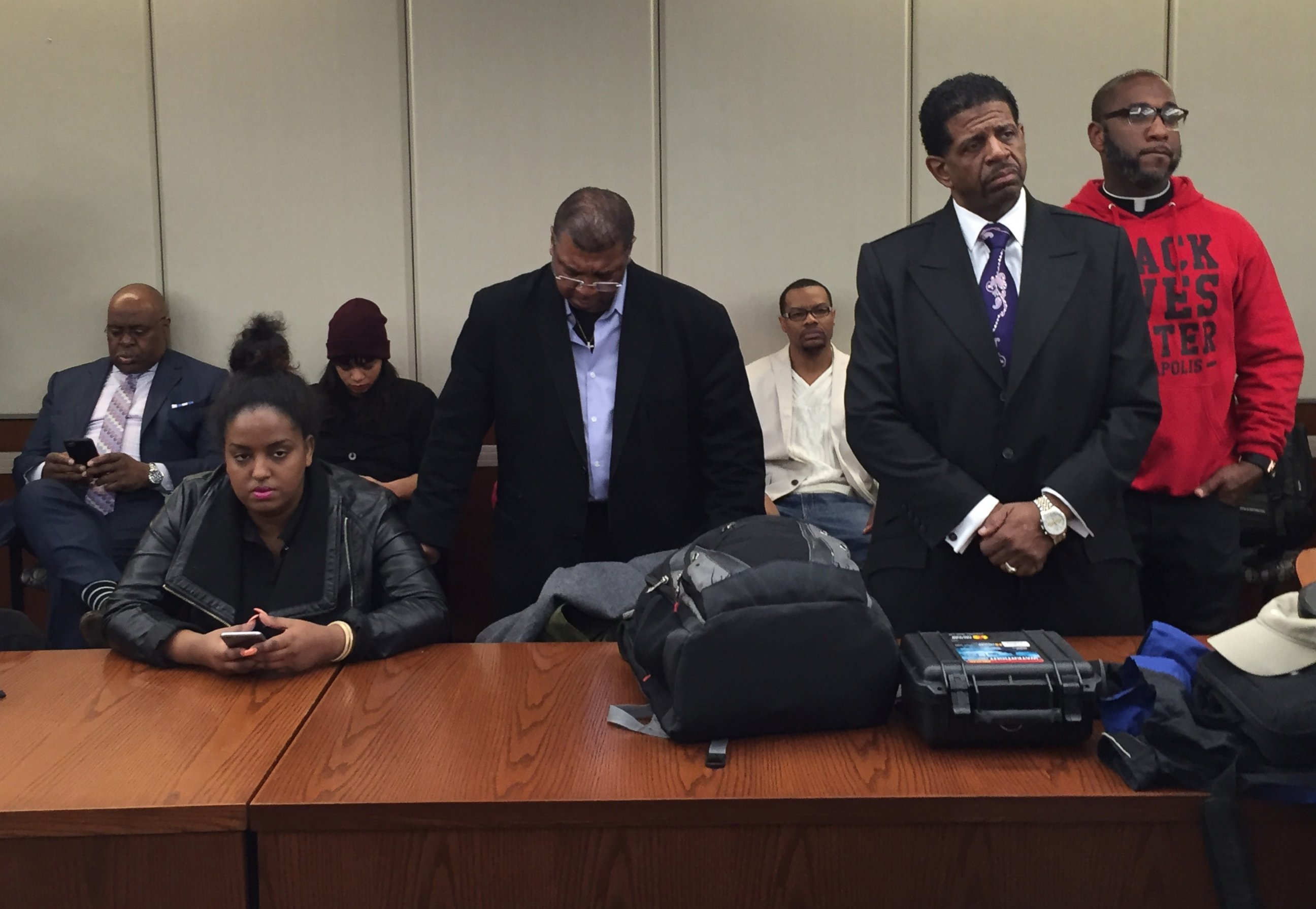 PHOTO: People listen as the Hennepin County Attorney announces that two Minneapolis police officers will not be charged in the November fatal shooting of Jamar Clark during a press conference, March 30, 2016 in Minneapolis.