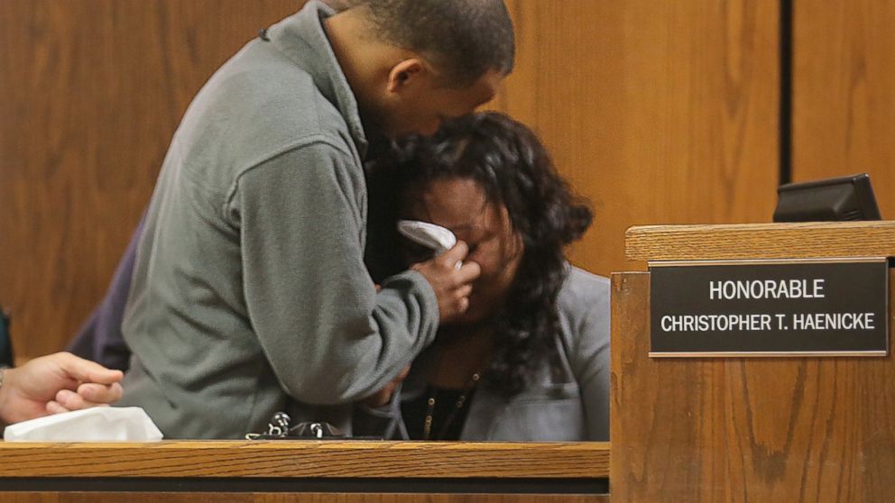 Kalamazoo County Court staff and family comfort Tiana Carruthers on the witness stand  after an outburst by defendant Jason Dalton during his preliminary examination in district court, May 20, 2016 in Kalamazoo, Mich.