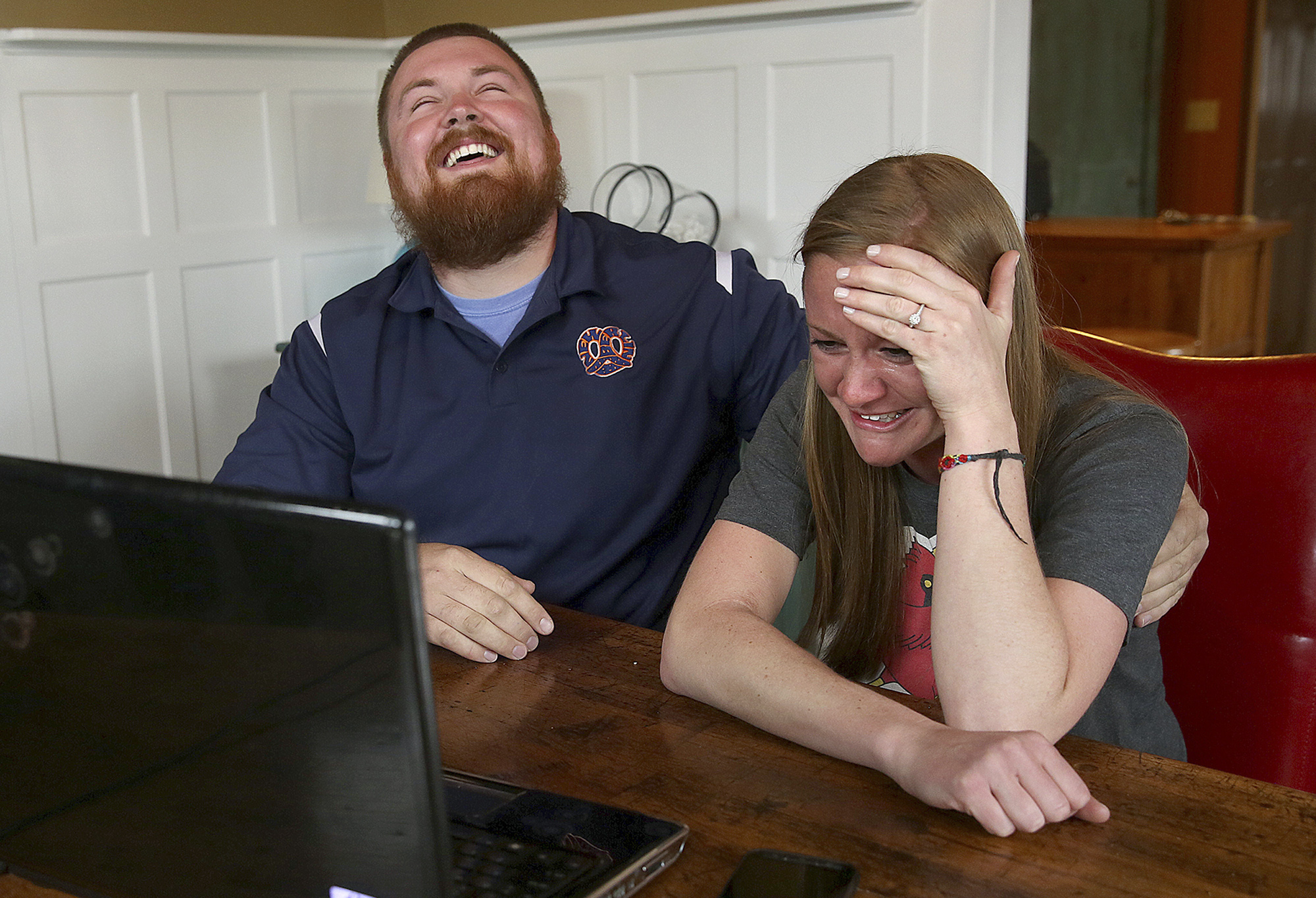 PHOTO: In this Monday, April 6, 2015 photo, Joel Burger and Ashley King react at King?s home in New Berlin, Ill., after learning from a New York public relations firm that Burger King has offered to pay the expenses and provide gifts for their wedding.