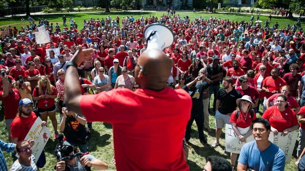 PHOTO: Jonathan Butler encourages a crowd to scream while using a megaphone during a "day of action" to celebrate graduate students and draw attention to demands on Aug. 26, 2015, near the columns on the University of Missouri campus, in Columbia, Mo.