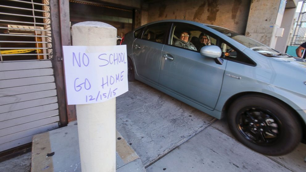 PHOTO: A vehicle leaves the Miguel Contreras Learning Complex past a sign that reads "No School Go Home," Dec. 15, 2015, in Los Angeles.