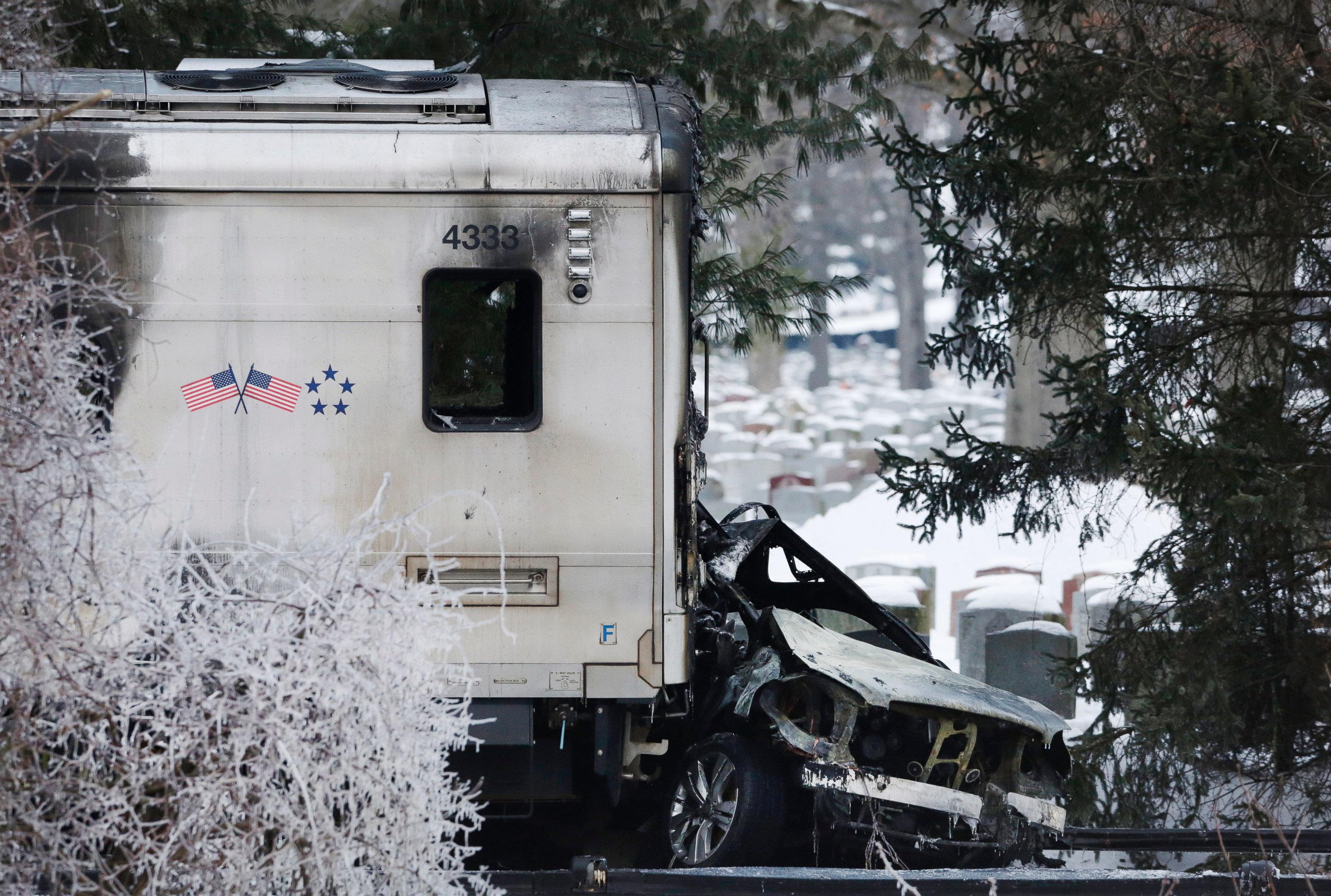 PHOTO: A sports utility vehicle remains crushed and burned at the front of a Metro-North train, on Feb. 4, 2015, in Valhalla, N.Y.  