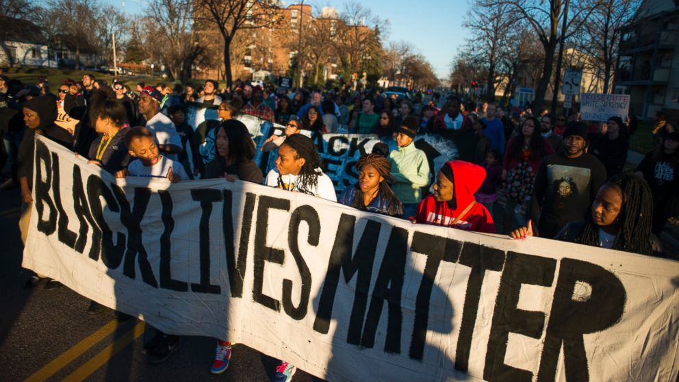 Neighbors and community members gathered at the scene where a man was shot and wounded by a Minneapolis Police officer early Sunday, Nov. 15, 2015.