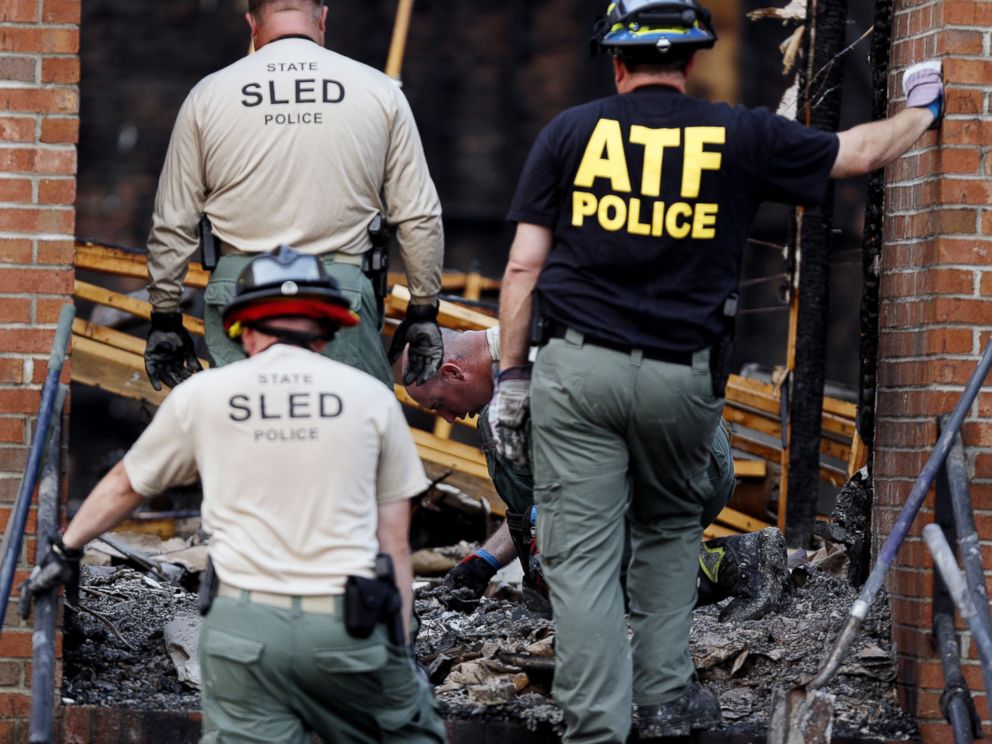 PHOTO: Investigators from the BATF and the South Carolina Law Enforcement Division sift through ashes and charred debris inside the Mount Zion African Methodist Episcopal church, July 1, 2015, in Greeleyville, S.C.
