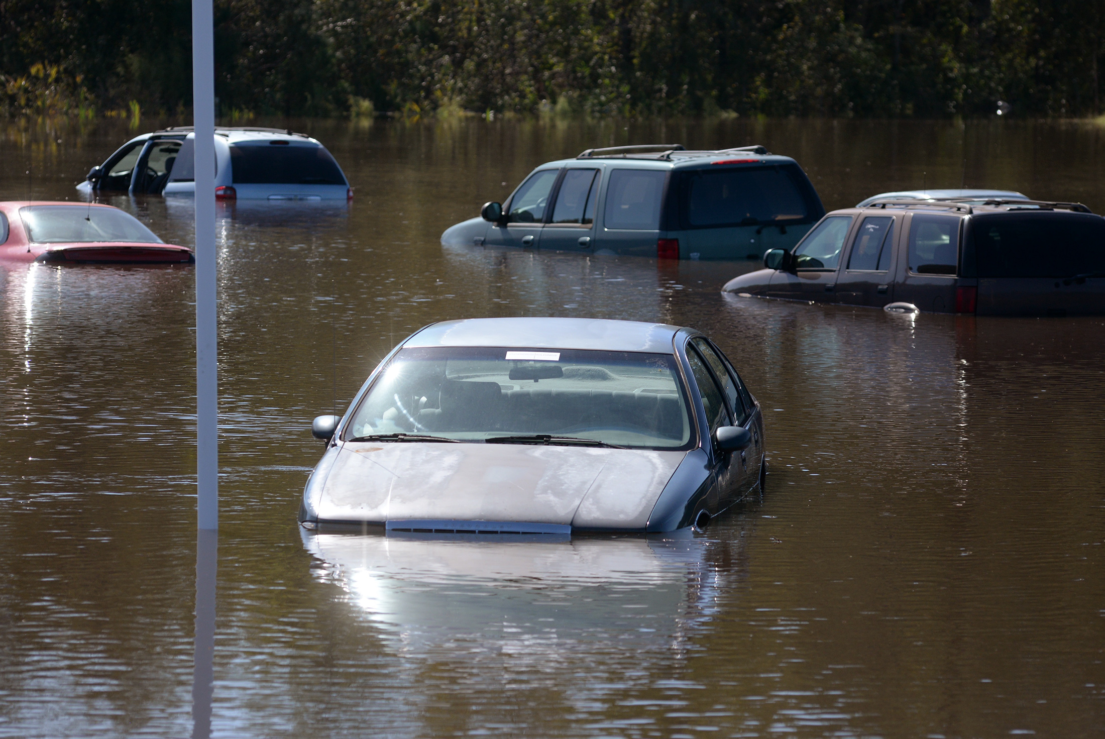 PHOTO: Used cars submerged in lot in flood waters rest along US 70W in Kinston, North Carolina, Oct. 12, 2016, as the Neuse River continues to rise.