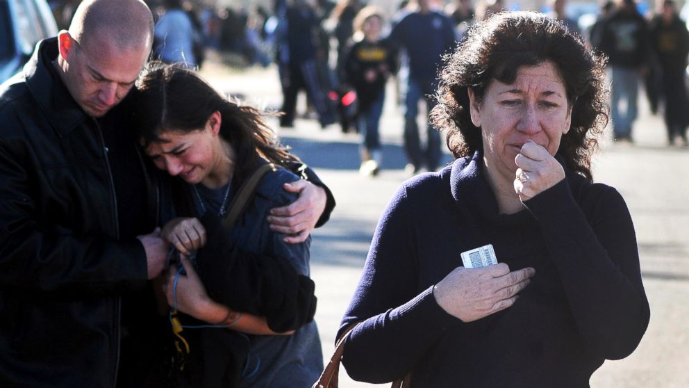 A woman waits at a staging ground area where families are being reunited with Berrendo Middle School students after a shooting at the school on  Jan. 14, 2014, in Roswell, N.M.