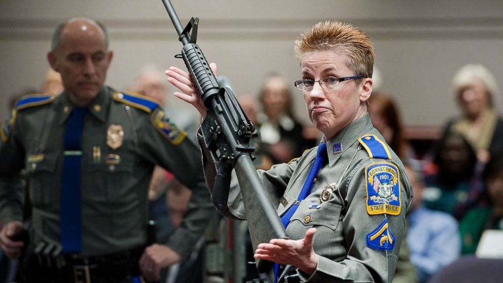 PHOTO: A Connecticut State Police officer holds up a Bushmaster AR-15-style rifle, the same make and model of gun used by Adam Lanza in the Sandy Hook School shooting at the Legislative Office Building in Hartford, Conn., Jan. 28, 2013.