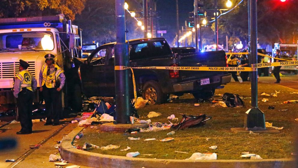 PHOTO: Police stand next to a pickup truck that slammed into a crowd and other vehicles, causing multiple injuries, coming to a stop against a dump truck, during the Krewe of Endymion parade in New Orleans, Saturday, Feb. 25, 2017. 