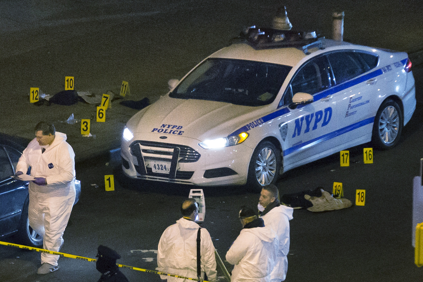 PHOTO: Bulletproof vests lie on each side of an NYPD patrol car as investigators work at the scene where two NYPD officers were shot in the Bedford-Stuyvesant neighborhood of the Brooklyn borough of New York on Saturday, Dec. 20, 2014.