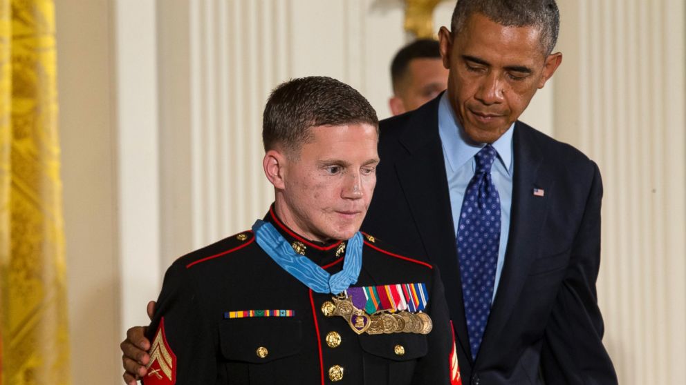 President Barack Obama reaches out to retired Marine Cpl. William "Kyle" Carpenter, after awarding him the Medal of Honor for conspicuous gallantry, June 19, 2014, during a ceremony in the East Room of the White House in Washington.