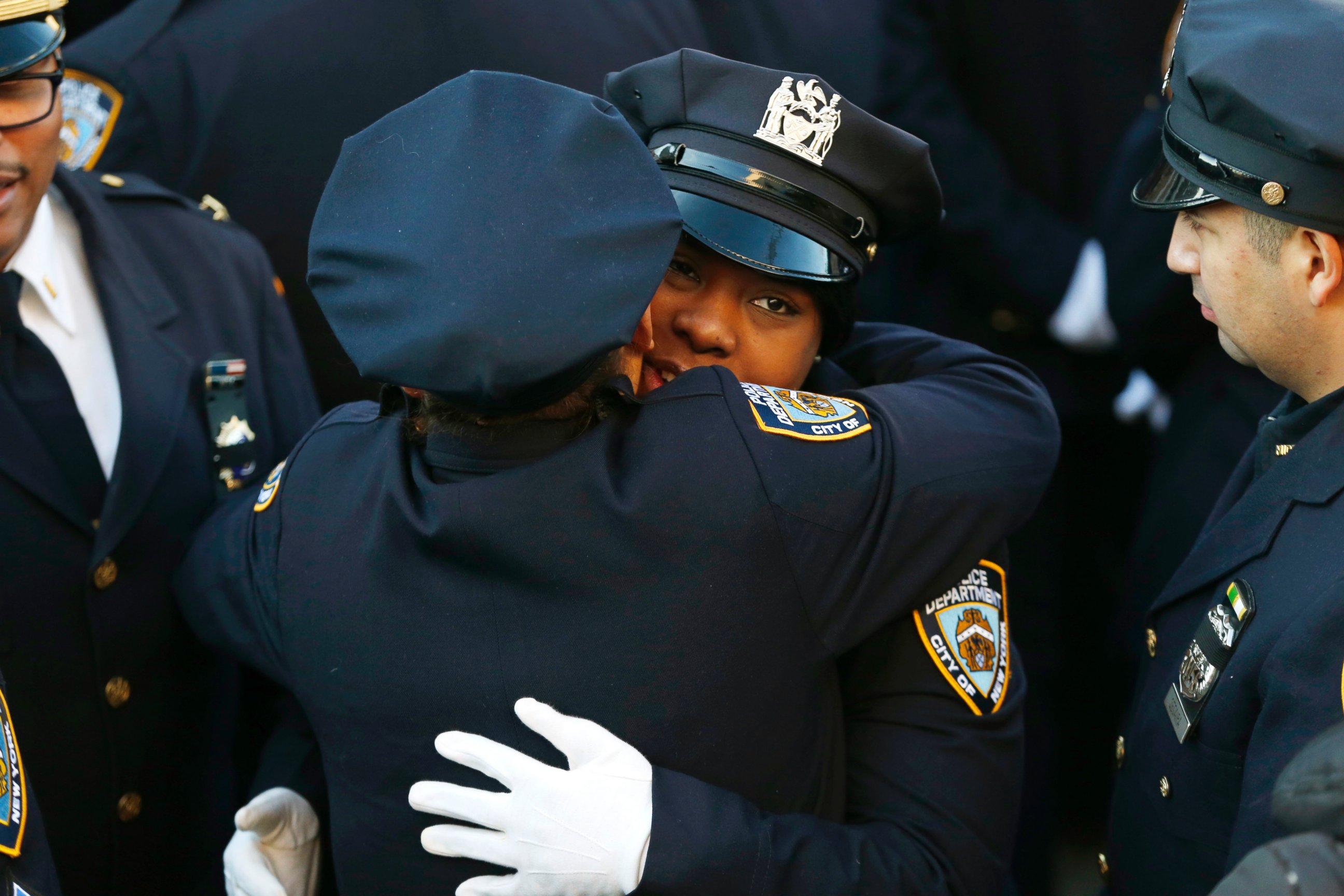 PHOTO: New York City police officers embrace outside of Christ Tabernacle Church, in the Glendale section of Queens, before funeral services for officer Rafael Ramos, Saturday, Dec. 27, 2014, in New York.