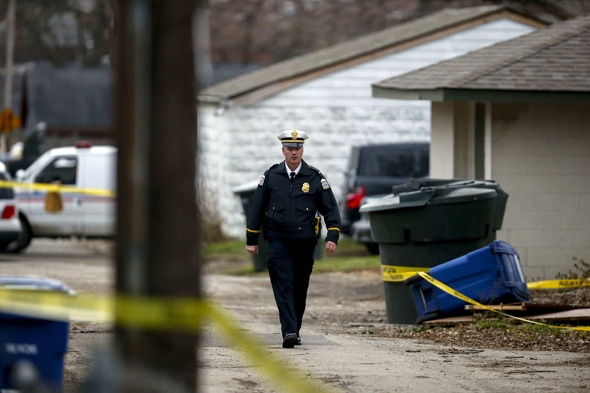 PHOTO: A police officer walks through the alley near 6th Avenue and Cortland Avenue in Columbus, Ohio where the body of missing Ohio State football player, Kosta Karageorge was discovered in a dumpster on Nov. 30, 2014. 