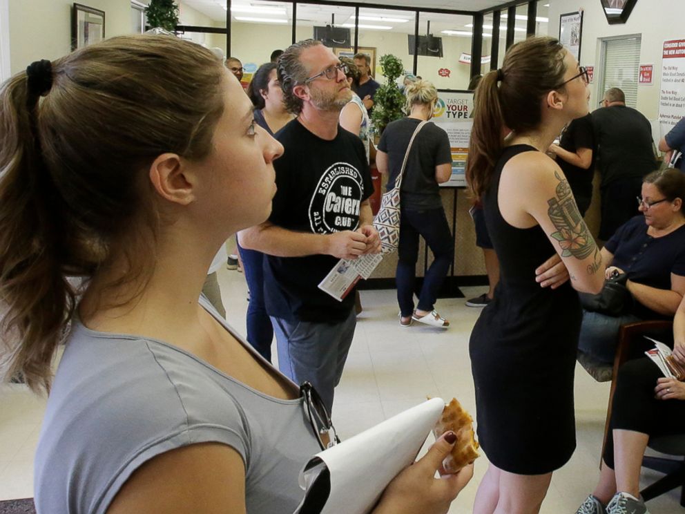 PHOTO: Volunteers waiting at a blood bank watch President Barack Obama deliver remarks on a TV, June 12, 2016, in Orlando, Fla. 