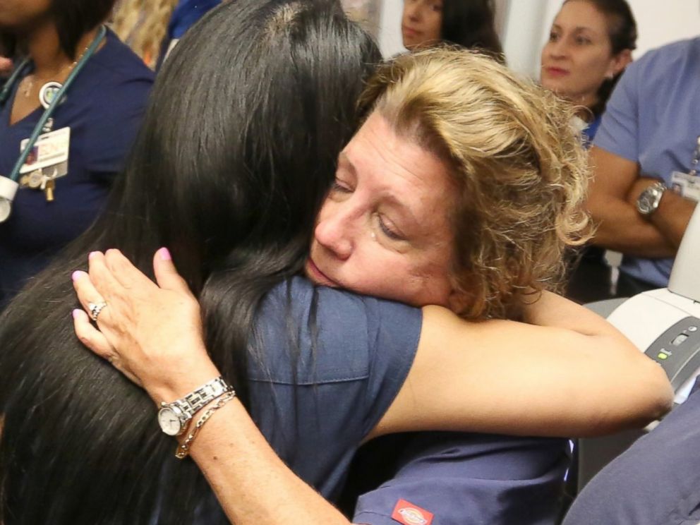 PHOTO: Doctors, nurses and first-responders hug after a brief prayer service in the emergency room at Florida Hospital in Orlando, Fla., June 15, 2016, to honor the victims of the Pulse nightclub mass shooting.