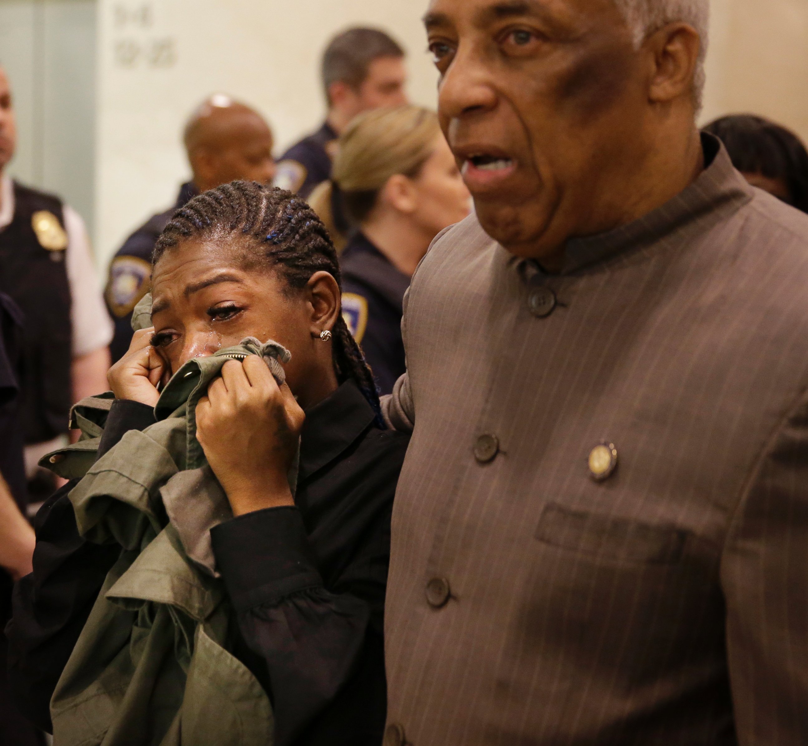 PHOTO: Melissa Butler, Akai Gurley's girlfriend, cries as she is escorted out of the courtroom by Assemblyman Charles Barron in New York, Tuesday, April 19, 2016.