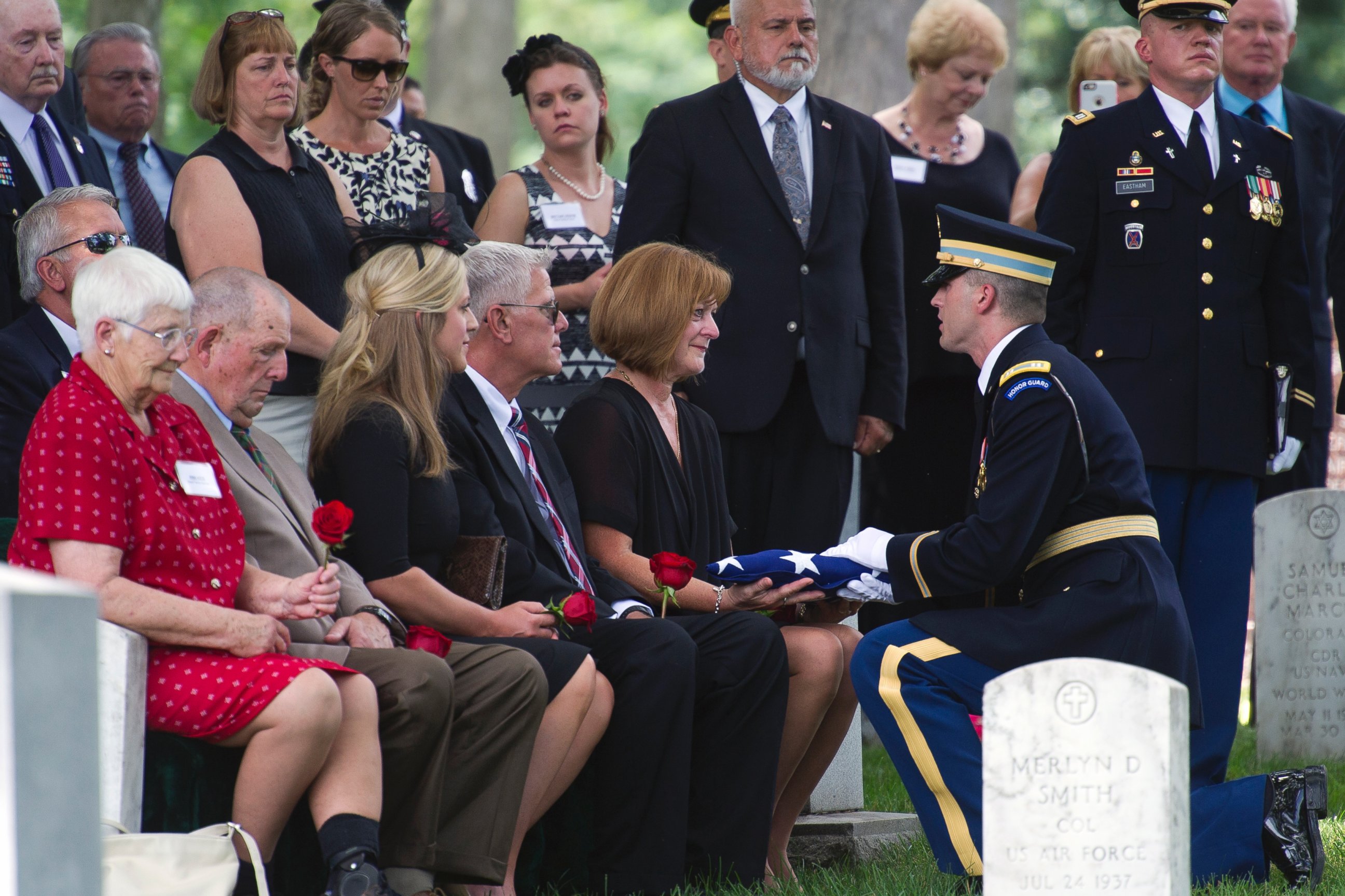 PHOTO: Army Capt. Carson Filipowski presents the flag which covered the casket of Army Air Forces 2nd Lt. John Herb of Cleveland, Ohio, to Peggy Herb, wife of his cousin Michael Herb, during his burial services at Section 30.