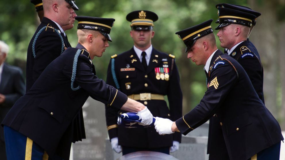 Members of the Army's 3rd Infantry Regiment, The Old Guard, fold the flag which covered the casket containing the remains of Army Air Forces 2nd Lt. John Herb of Cleveland, Ohio, during burial services in Section 30 of Arlington National Cemetery in Arlington, Va., June 18, 2015. 