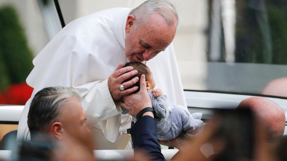 PHOTO: Pope Francis passes the crowd and kisses a baby in his pope mobile in Philadelphia on Saturday, Sept. 26, 2015.