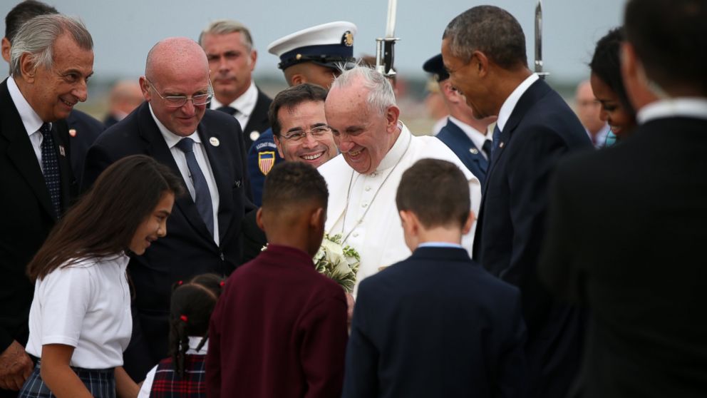 Pope Francis, accompanied by President Barack Obama, and others, is greeted upon his arrival at Andrews Air Force Base, Md., Sept. 22, 2015.