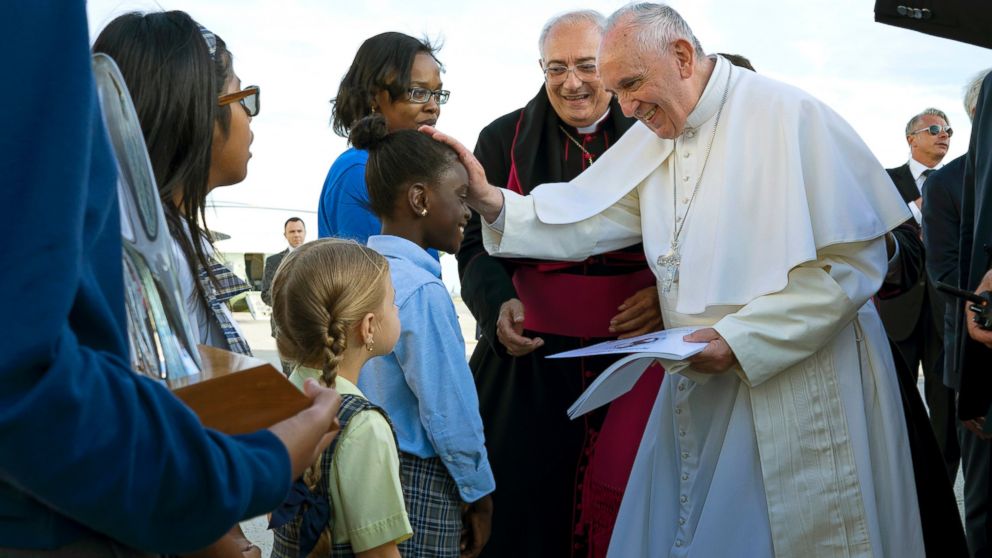PHOTO: Pope Francis reaches out to 5th grader Omodele Ojo, of New York, as he is greeted while arriving at John F. Kennedy International Airport, Sept. 24, 2015, in New York.