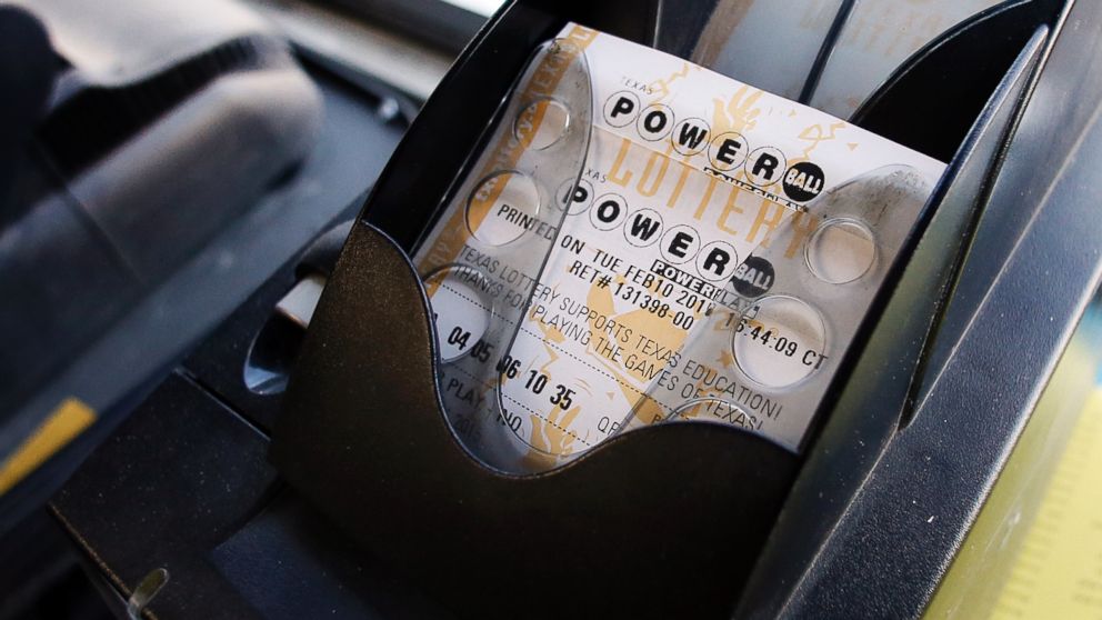 A Powerball ticket sits in the tray dispenser after being printed out for a customer at Fuel City in Dallas, Feb. 10, 2015.