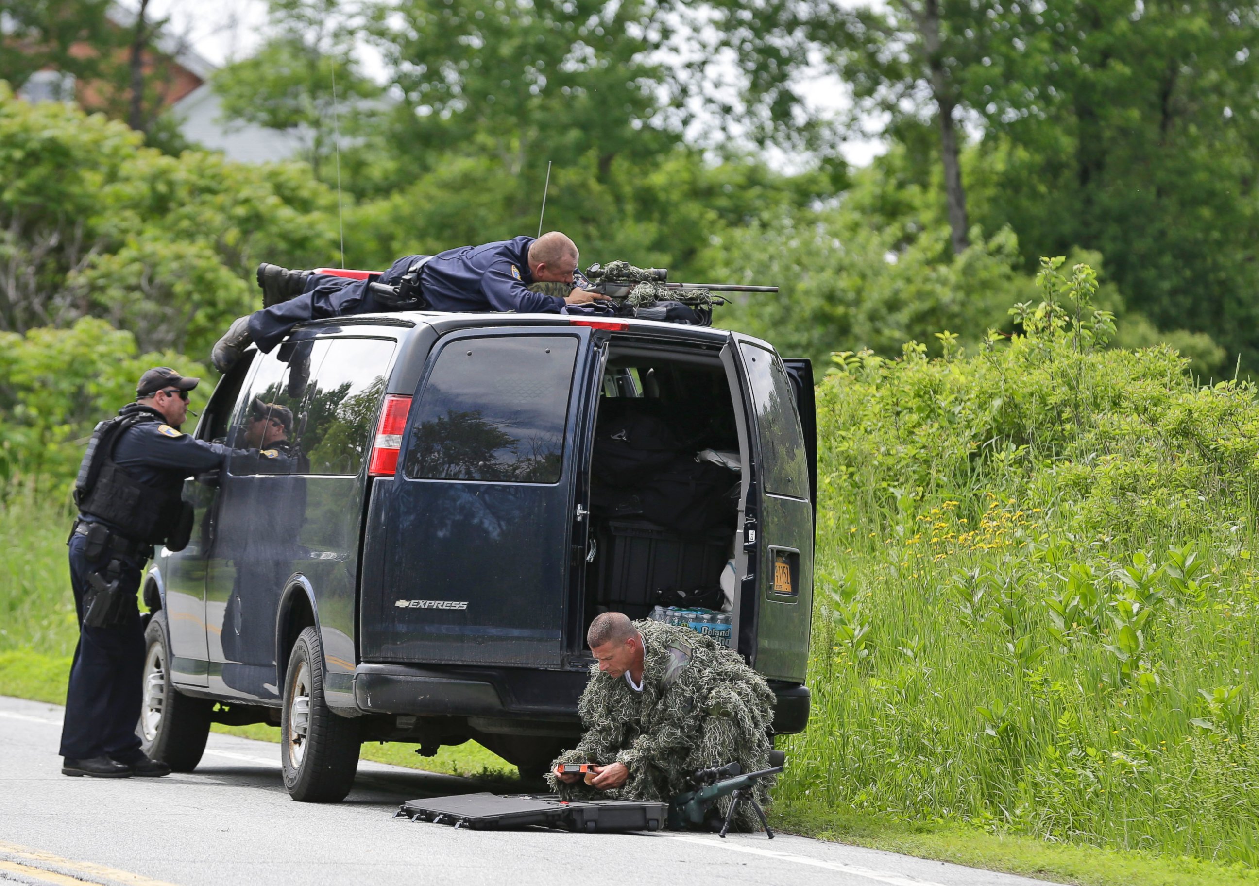 PHOTO: A heavily armed law enforcement officer patrols the edge of road during a search for two escaped killers in Boquet, N.Y., June 9, 2015. 