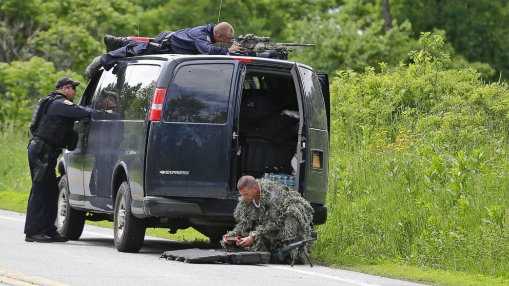 PHOTO: A heavily armed law enforcement officer patrols the edge of road during a search for two escaped killers in Boquet, N.Y., June 9, 2015. 