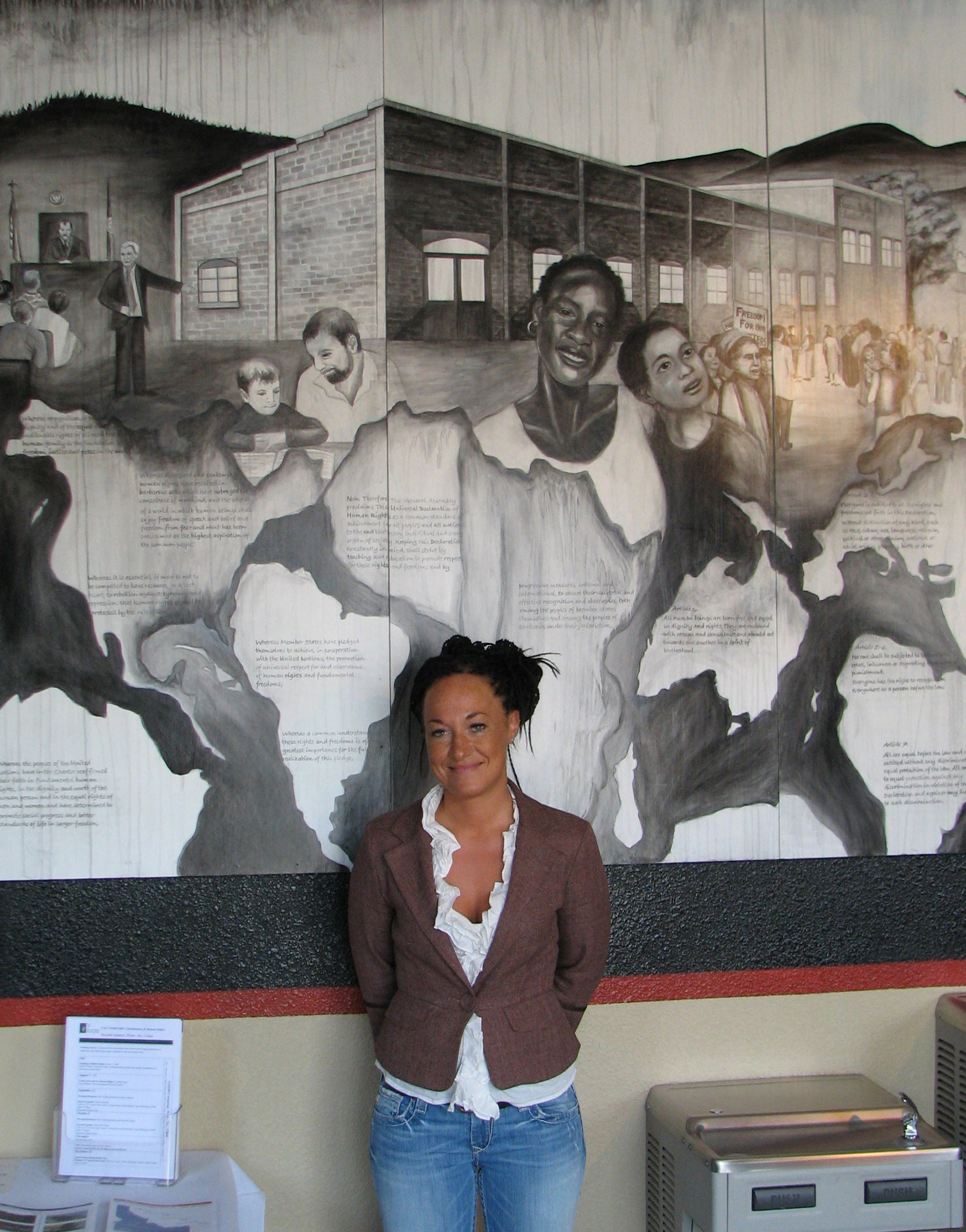 PHOTO: In this July 24, 2009, file photo, Rachel Dolezal, a leader of the Human Rights Education Institute, stands in front of a mural she painted at the institute's offices in Coeur d'Alene, Idaho. 