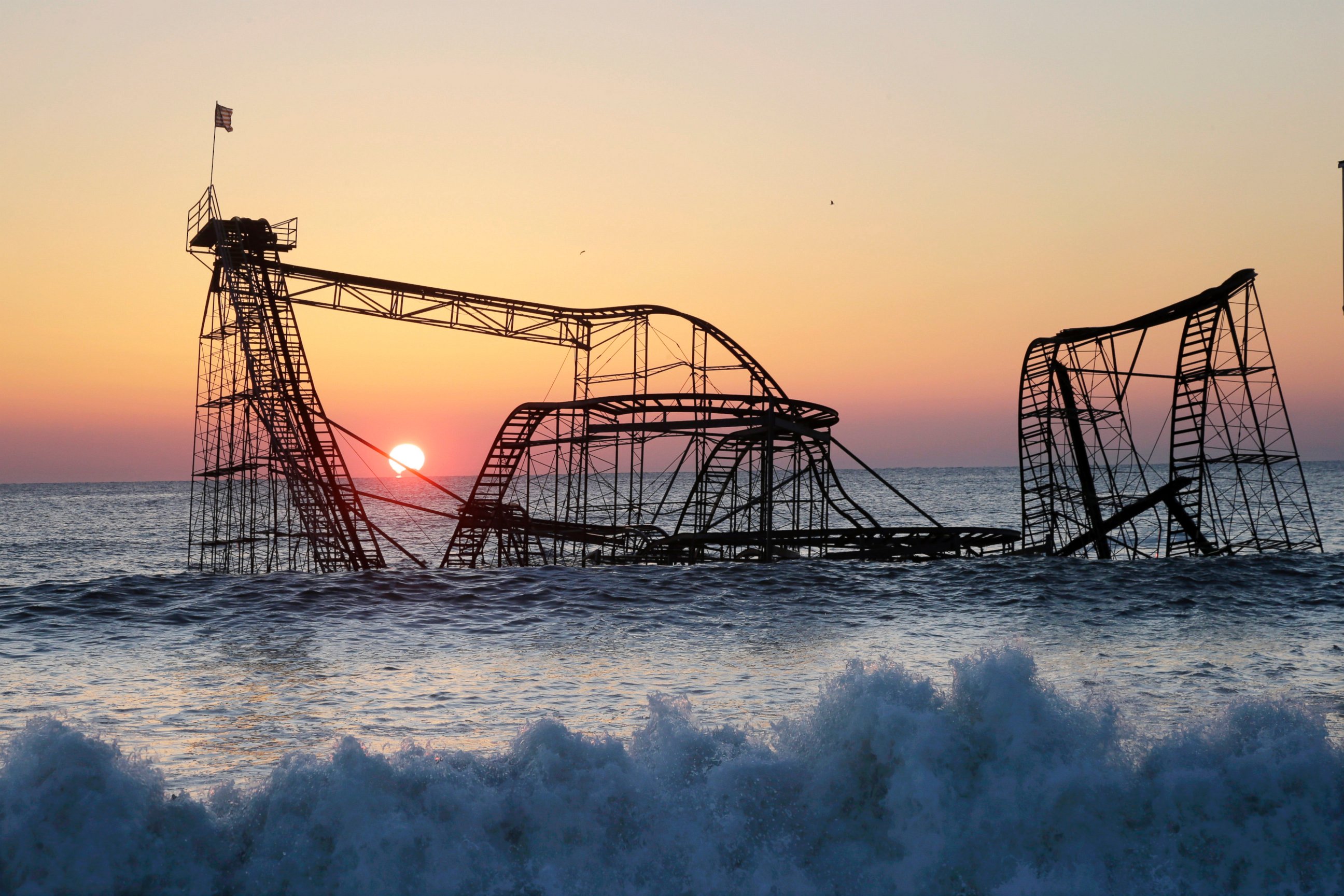 PHOTO: The sun rises in Seaside Heights, N.J., Feb. 25, 2013, behind the Jet Star Roller Coaster which was sitting in the ocean after part of the Funtown Pier was destroyed during Superstorm Sandy.