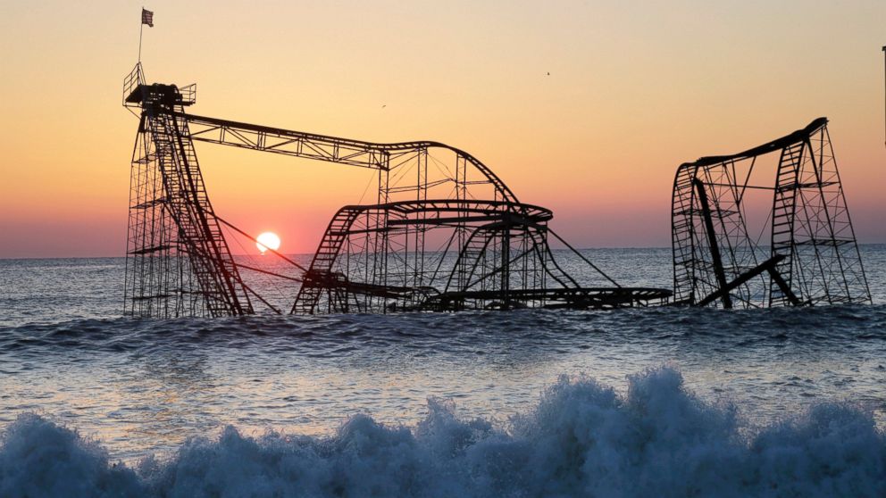 PHOTO: The sun rises in Seaside Heights, N.J., Feb. 25, 2013, behind the Jet Star Roller Coaster which was sitting in the ocean after part of the Funtown Pier was destroyed during Superstorm Sandy.
