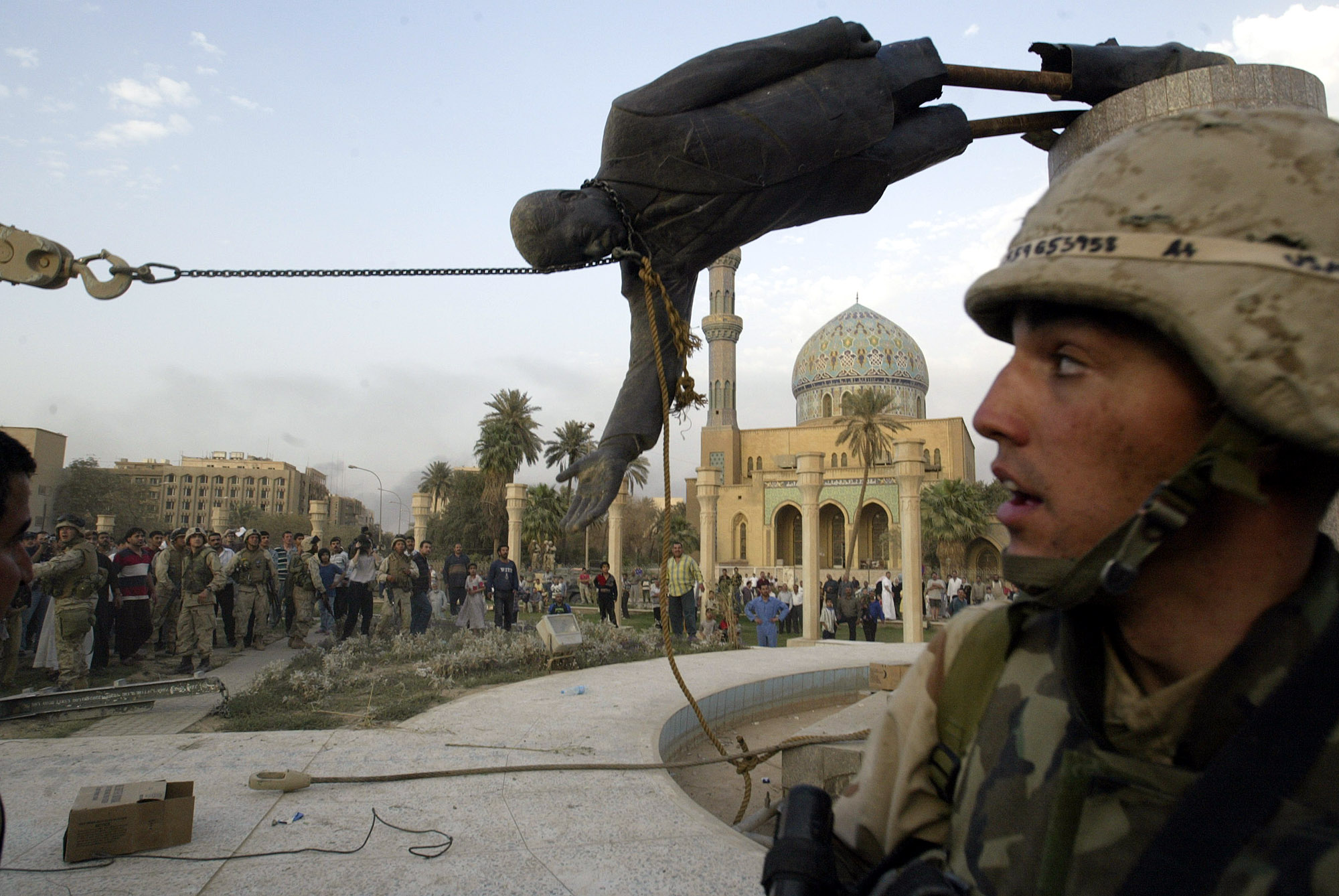 PHOTO: The April 9, 2003 file photo shows Iraqi civilians and U.S. soldiers pulling down a statue of Saddam Hussein in downtown Baghdad. 