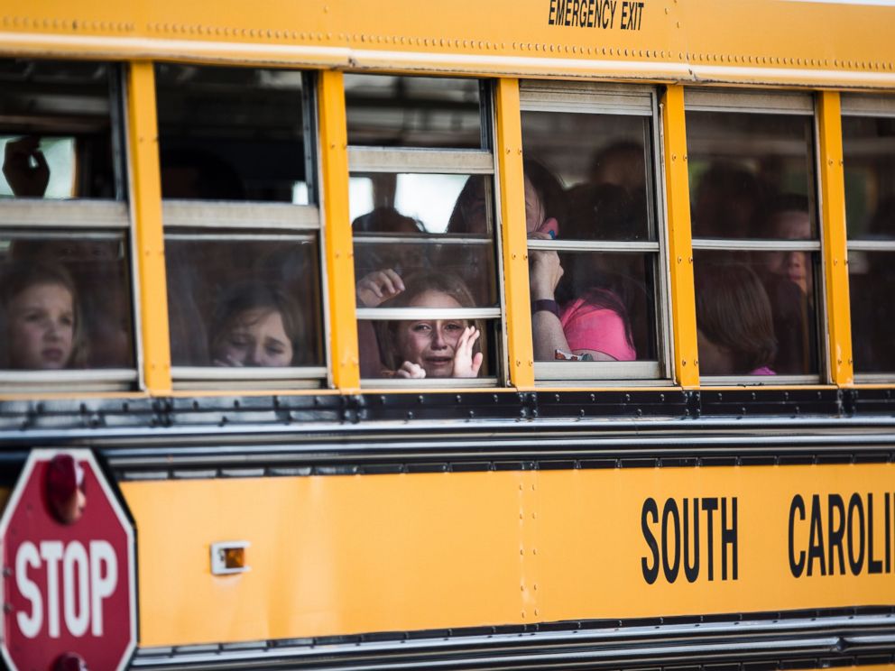 PHOTO: A student looks out of the window of a school bus as she and her classmates are transported to Oakdale Baptist Church following a shooting at Townville Elementary, Sept. 28, 2016.
