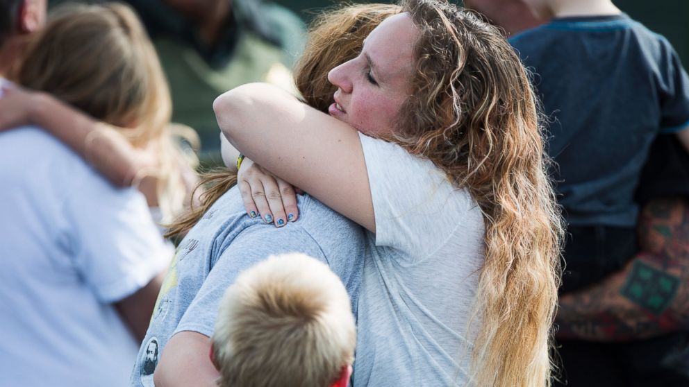 PHOTO: Korrie Bennett hugs Heather Bailey after recovering their children following a shooting at Townville Elementary in Townville, Sept. 28, 2016.