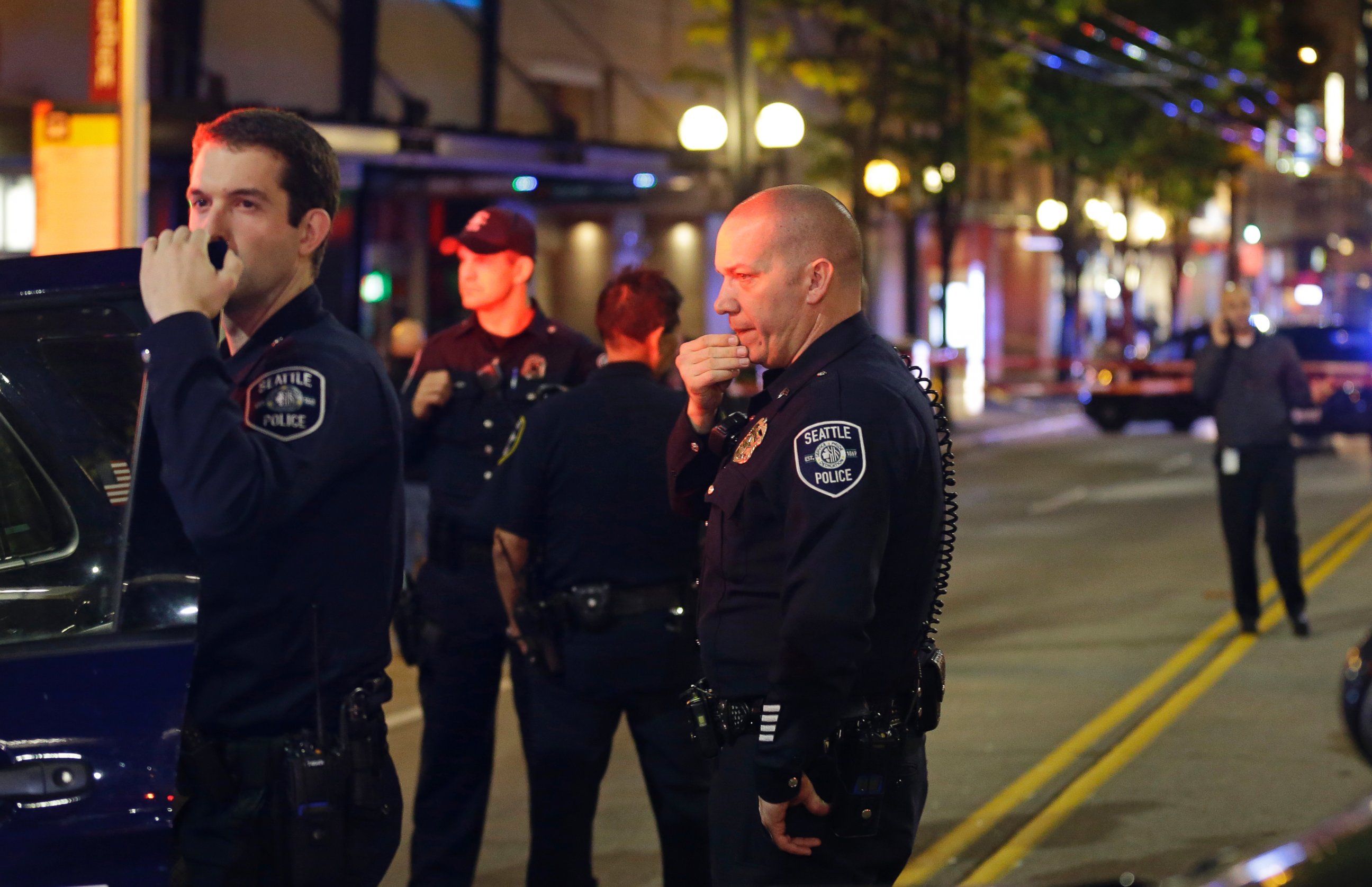 PHOTO: Police officers wait near a car near the scene of a shooting Wednesday, Nov. 9, 2016, in downtown Seattle.