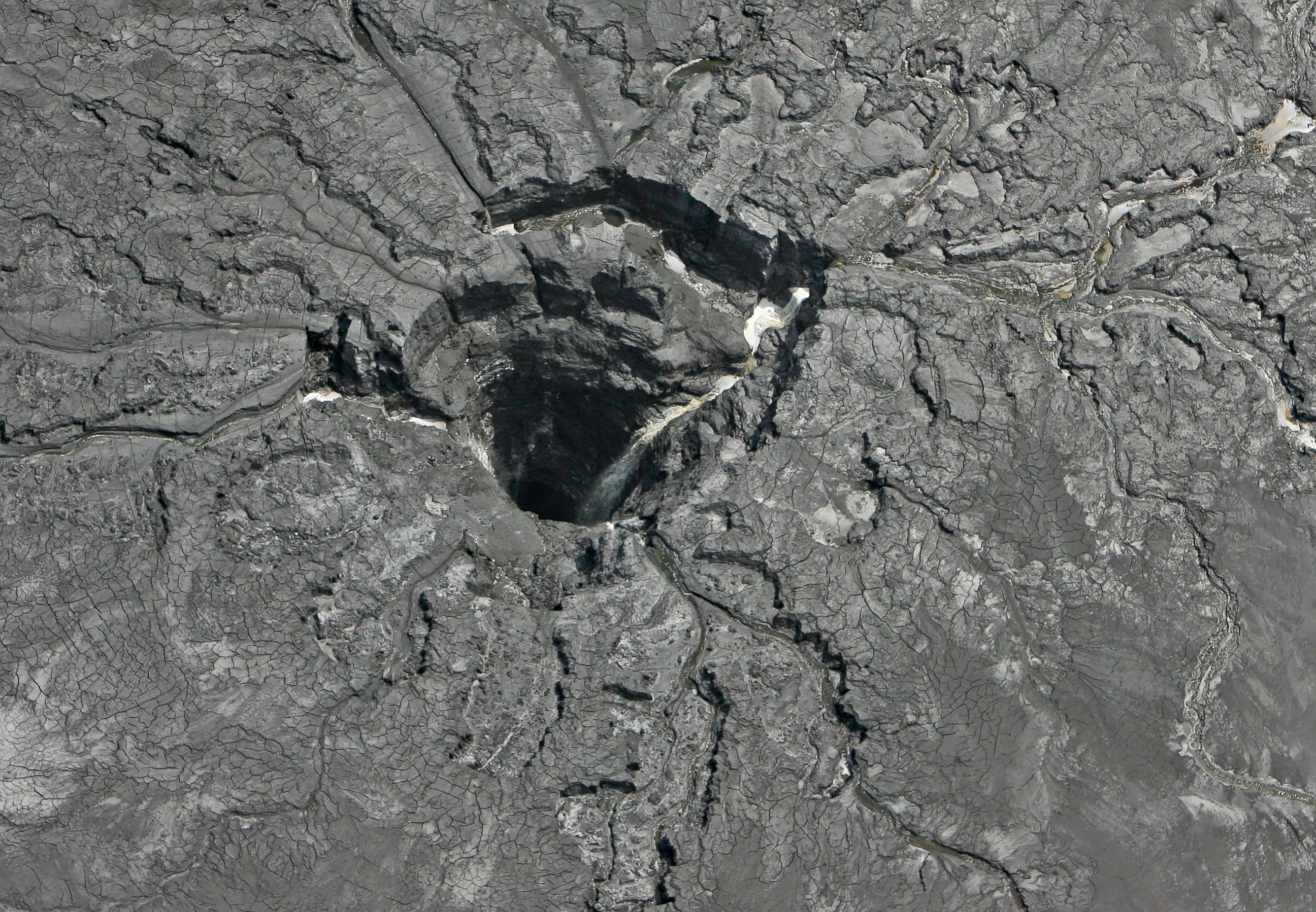 PHOTO: This aerial photo shows a massive sinkhole Friday, Sept. 16, 2016, in Mulberry, Florida, that opened up underneath a gypsum stack at a Mosaic phosphate fertilizer plant.