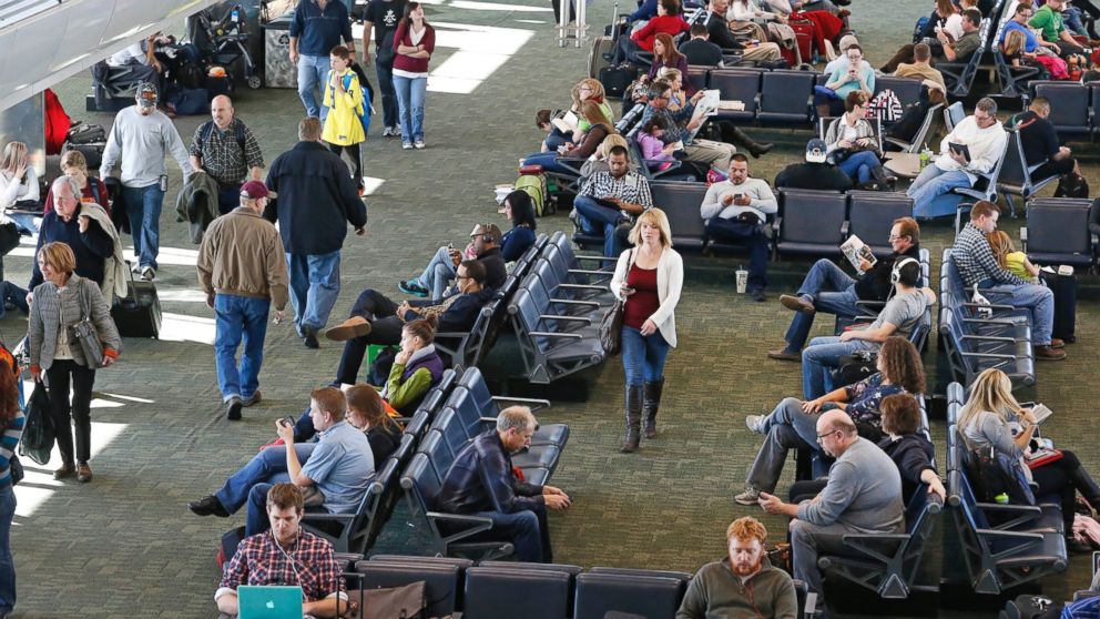 On the busiest travel day of the year, passengers wait for flights inside a terminal at Denver International Airport, Nov. 27, 2013. 