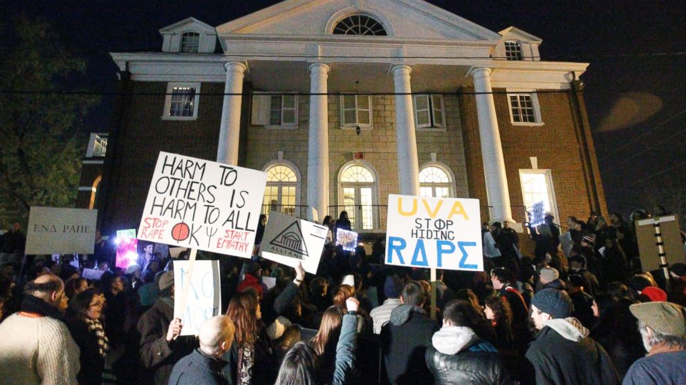 PHOTO: Protestors carry signs and chant slogans in front of the Phi Kappa Psi fraternity house at the University of Virginia, Nov. 22, 2014, in Charlottesville, Va.
