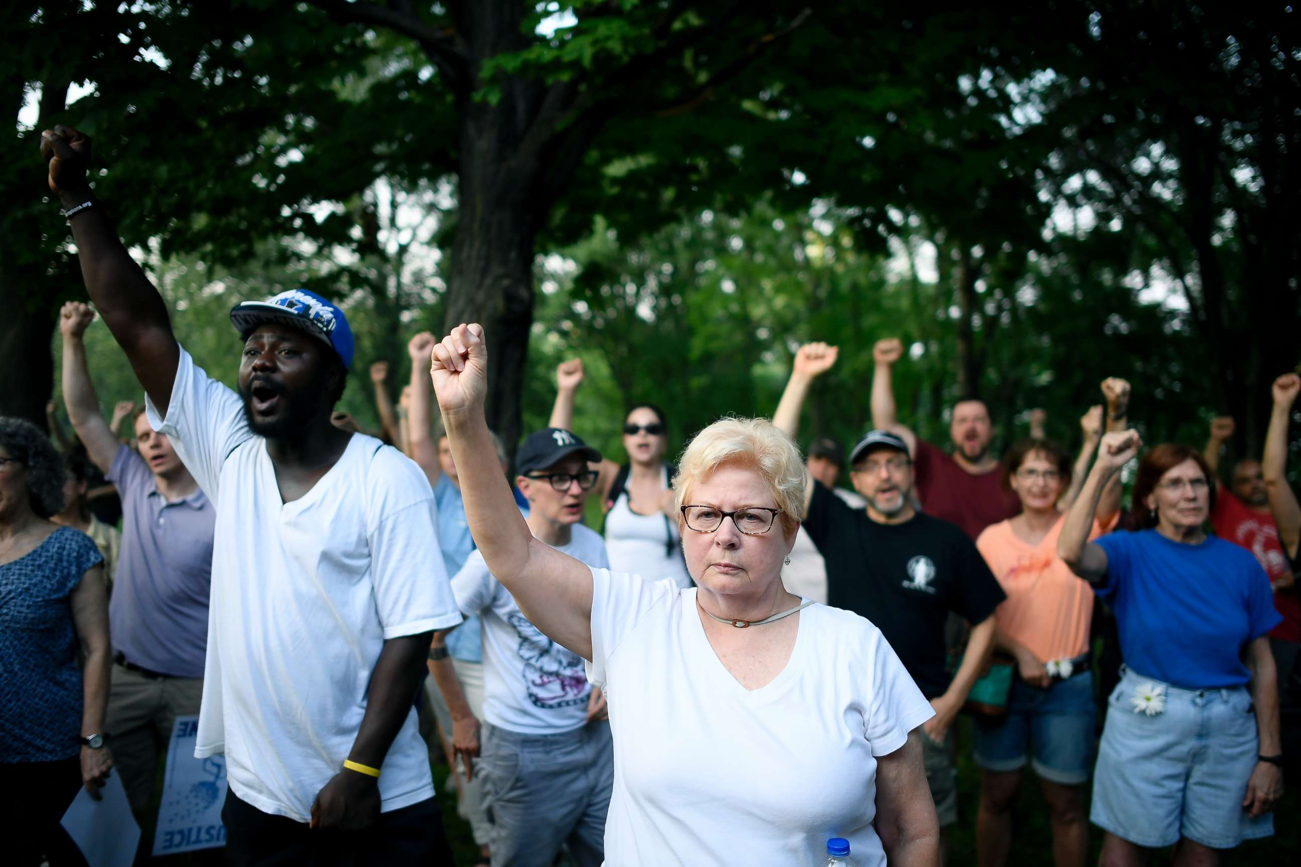 PHOTO: Jan Skogstrom, of Minneapolis, raises her fist with fellow protesters during a march in honor of Justine Damond at Beard's Plaissance Park  Thursday, July 20, 2017, in Minneapolis.