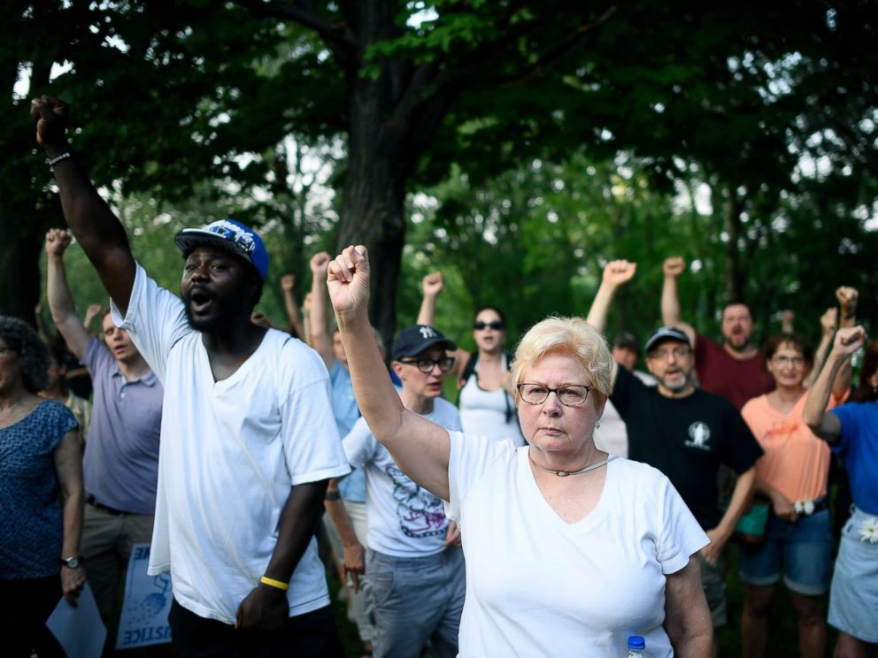PHOTO: Jan Skogstrom, of Minneapolis, raises her fist with fellow protesters during a march in honor of Justine Damond at Beards Plaissance Park Thursday, July 20, 2017, in Minneapolis.
