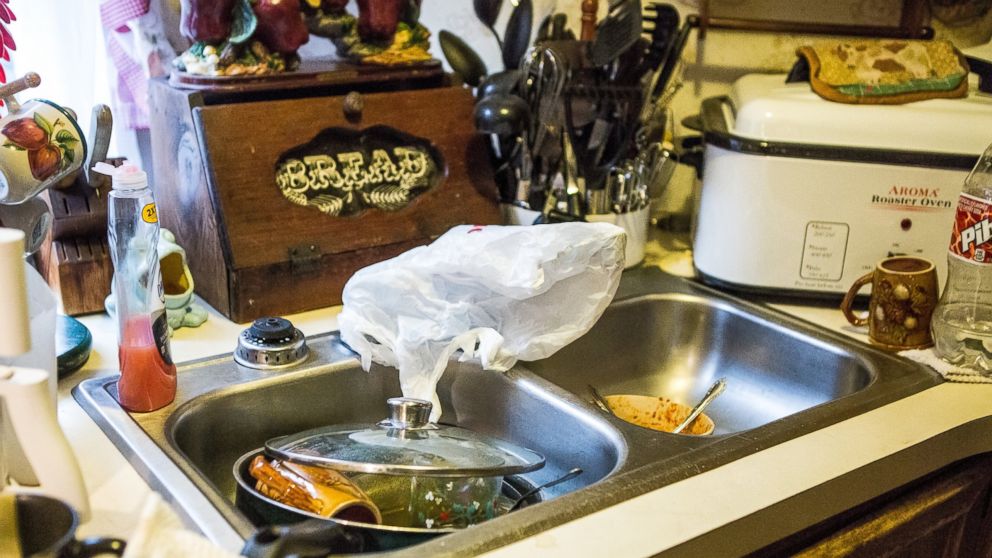 PHOTO: Bonnie Wireman of Dry Branch, W.Va has covered her kitchen faucets in a bag because she kept forgetting about the ban on using tap water for drinking and washing.