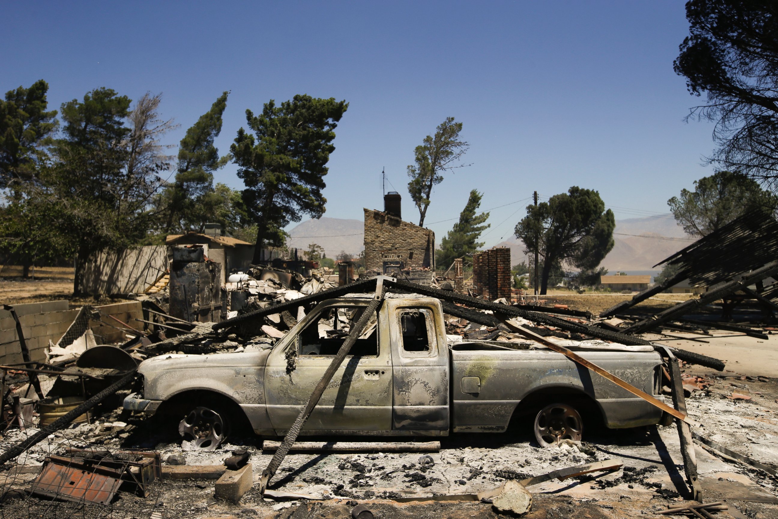 PHOTO: A pickup truck destroyed by a wildfire sits on a burned property, June 24, 2016, near Lake Isabella, Calif.