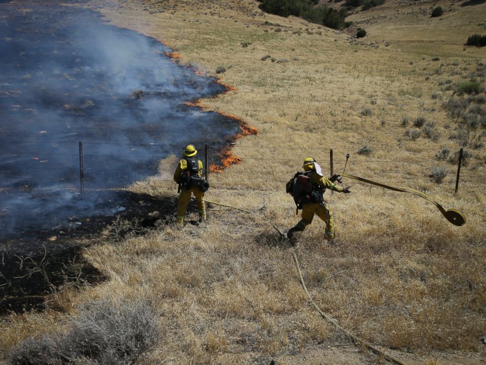 PHOTO: Firefighters prepare water hoses to battle a wildfire burning along Highway 178 near Lake Isabella, Calif., June 24, 2016.