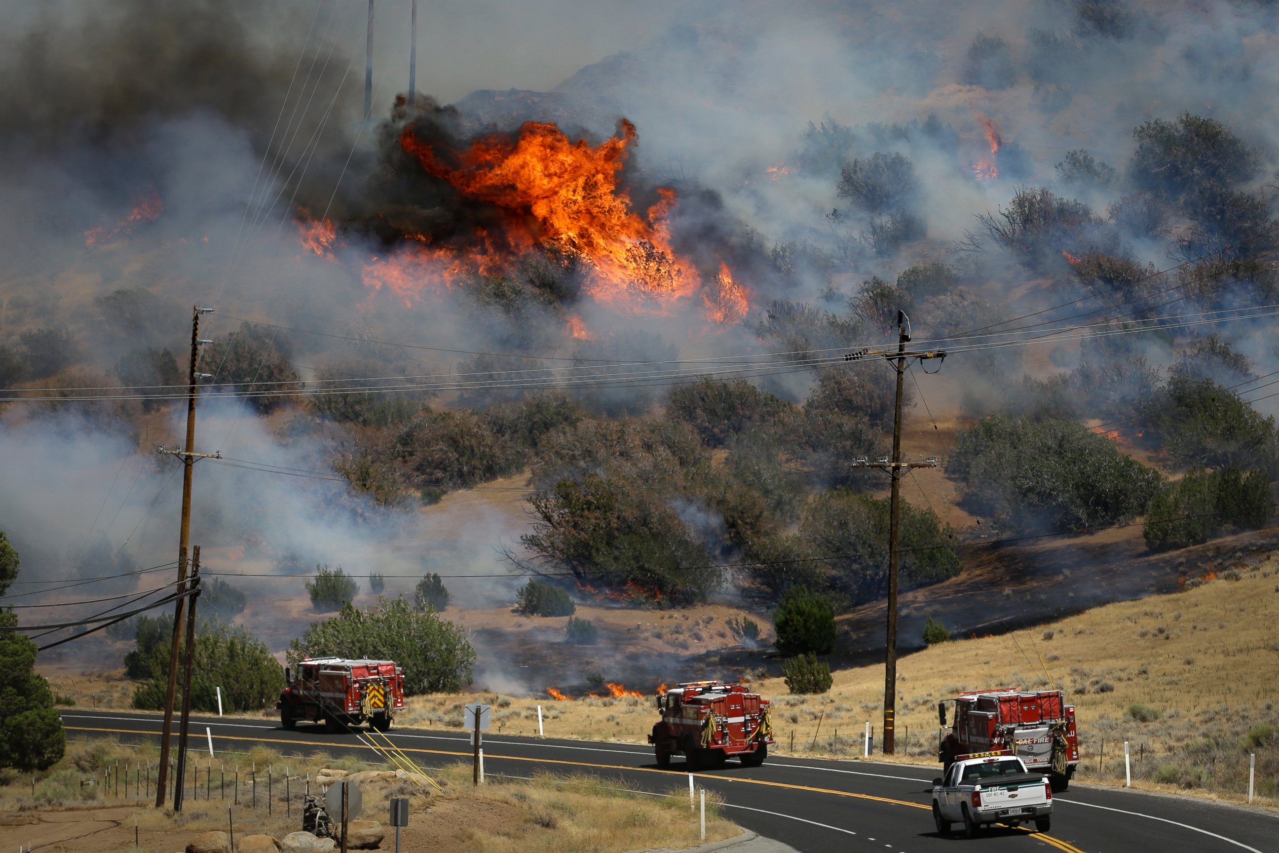 PHOTO: Fire trucks move along Highway 178 near Lake Isabella, Calif., June 24, 2016, as a wildfire continues to burn in the area.