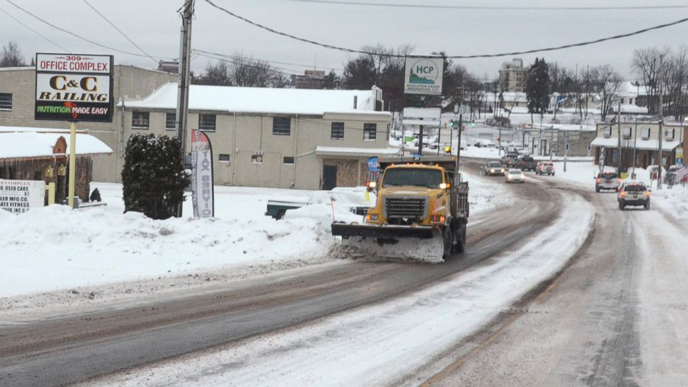 A driver of a PennDOT plow truck clears snow off of South Church Street, in Hazleton Pa., Jan. 26, 2015. 