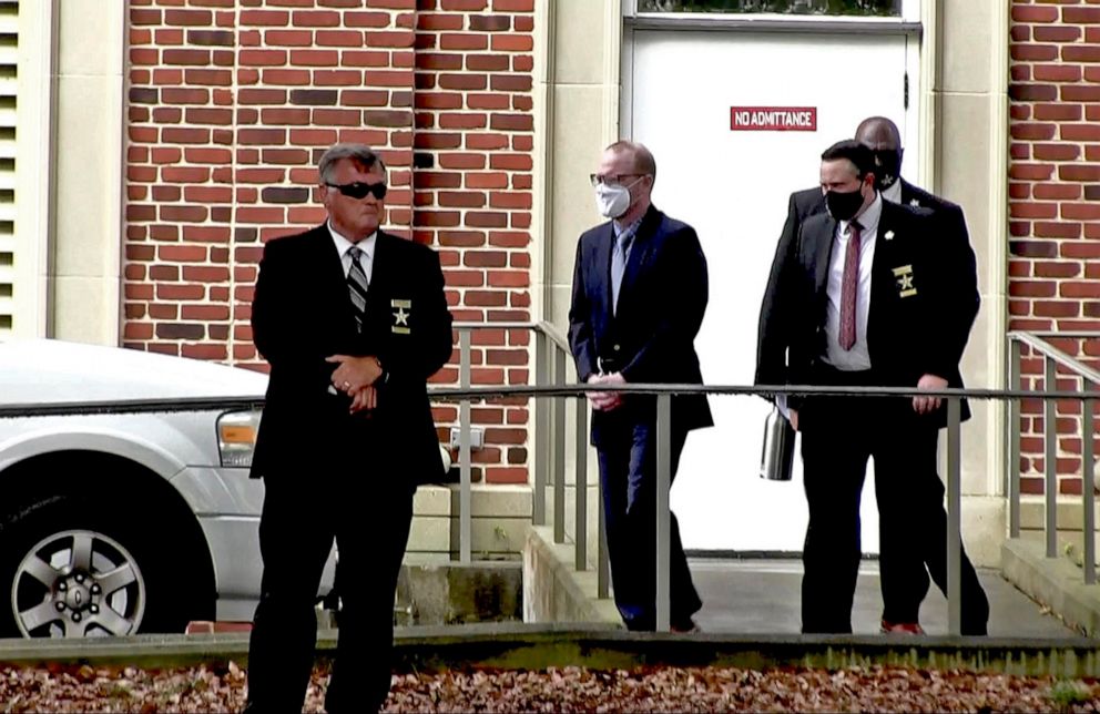 PHOTO: Travis McMichael, center, accused in the shooting death of Ahmaud Arbery, is led by security officers from the Glynn County Courthouse in Brunswick, Ga., May 12, 2021, in this image from video. 